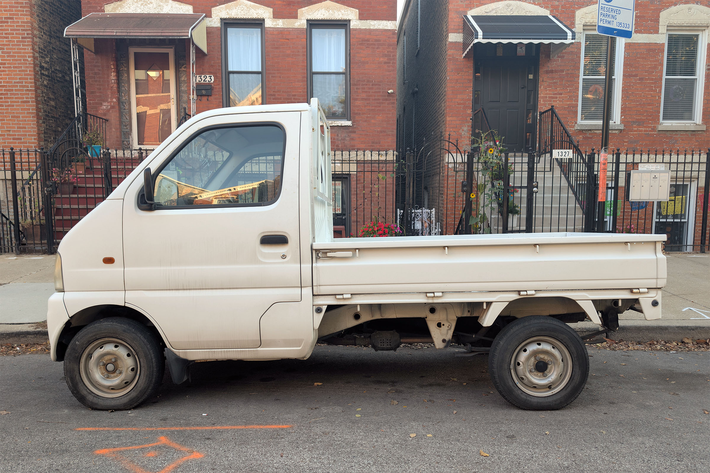 White Kei truck on city street